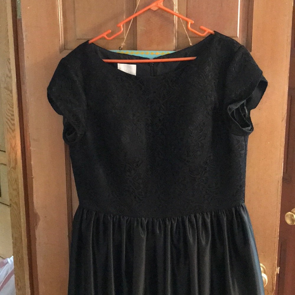 Knee length black vintage dress.